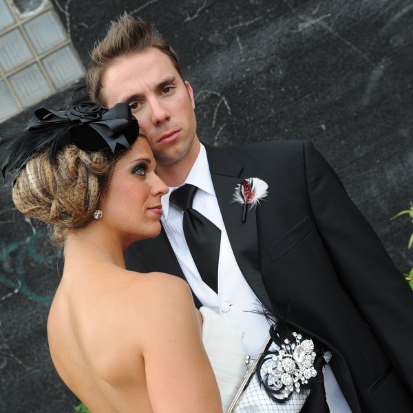 Bride and Groom. Bride carrying a handmade rhinestone and feather clutch bag by ANGEE W.