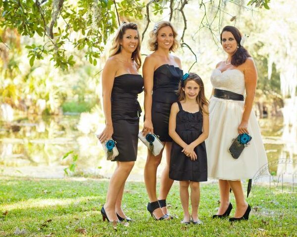 Bride and bridesmaids holding handmade ANGEE W. clutch bags